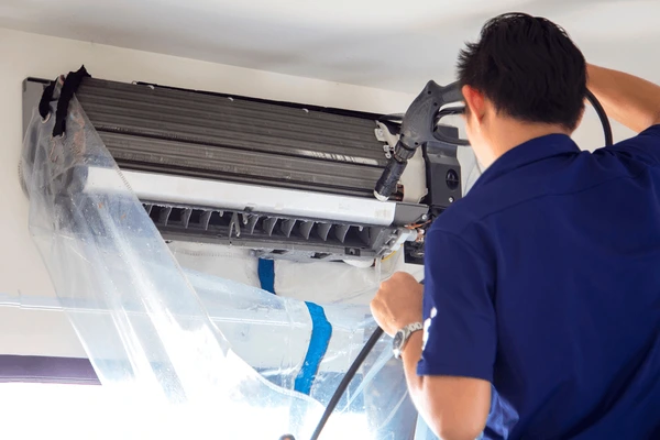 technicians cleaning air conditioner by 600nw 1726475164